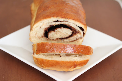 a loaf of nutella swirl bread on a white plate