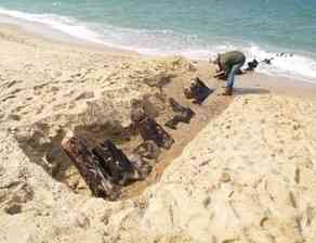 Parts of the Revolutionary War British vessel HMS Somerset III peek through the sand on the coast of Cape Cod. Parts of the ship resurfaced for the first time in nearly 40 years in April 2010.  (Harry R. Feldman Inc.)