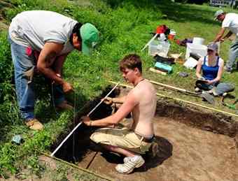 Ethan Klicko, center, a UW Baraboo Student, helps to set up a plan map at one of the dig sites in Trempealeau Wis. The plan map helps organize and catalogue any artifacts that are found. 