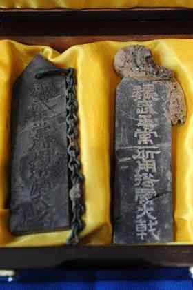 This photo taken on December 30, 2009 shows two stone plates excavated from the tomb of Cao Cao, a warlord during the Three Kingdoms period (208-280 A.D.), in Anyang of central China's Henan province