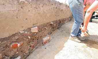 Volunteers at an archaeological dig in downtown Hampton work their way through layers of history on the site where the Old Point Bank building is going up. 