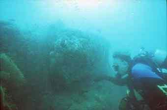 A diver explores the submerged ruins of Pumpuhar