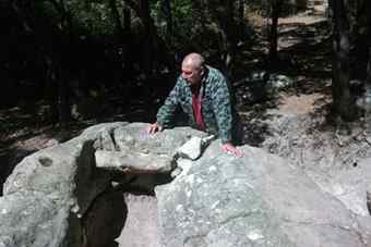 Bulgarian archaeologist Nikolay Ovcharov is pictured close to the entrance of one of the two newly found tombs at the holy rock city of the Thracians Perperikon. 