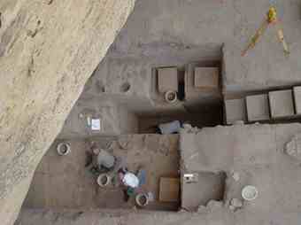 The North Creek Shelter, seen here from above, sits at the base of a sheer sandstone cliff.