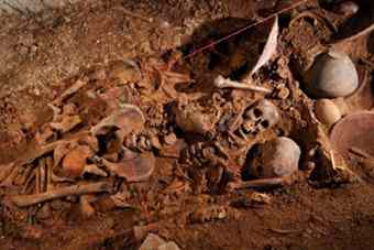 Bones from multiple skeletons and the remains of a wooden coffin  found in the southern room. Photo  by Marc Steinmetz.