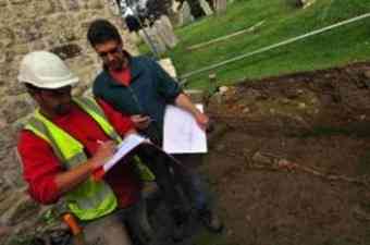 Archaeologists Mike Trevarthen and Peter Bellamy with one of the two children’s skeletons uncovered at St Mary’s Church 