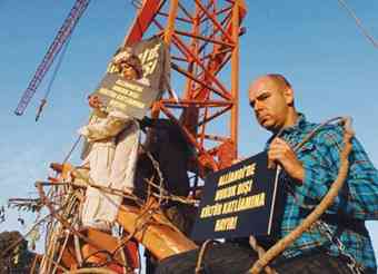 Police arrest environmental activists who chained themselves to a crane in protest of the destruction of the ancient city of Allianoi. 