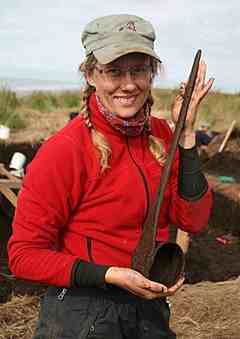 Dr. Charlotta Hillerdal, from University of Aberdeen, holds a bentwood ladle from a single piece of wood. (Courtesy Photo, Photo courtesy of Rick Knecht)