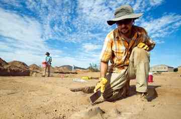 Field director Scott Courtright, of Phoenix, digs up artifacts.