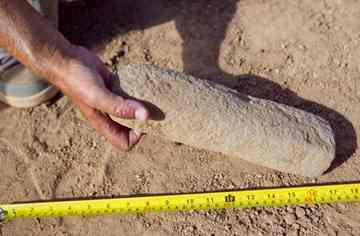 Hackbarth holds up a handstone used for grinding.