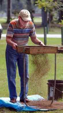 Bill Steed of Hortense sifts the soil and shell excavated from a test hole at Selden Park.