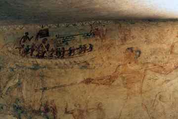 Rudj-Ka fishing in the marshes. Above him is a depiction of boating on the Nile.