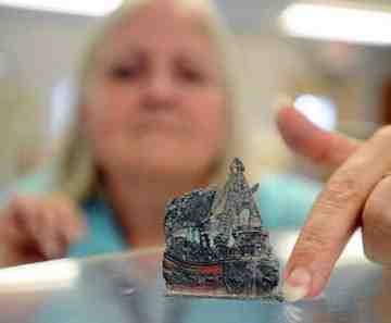 Delaware state archaeologist Faye Stocum shows a small cast pewter ship recovered from the shipwreck off Lewes. The many artifacts recovered help paint a picture of life in the 1770s. (The News Journal/GARY EMEIGH)