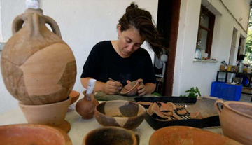 An archaeologist working to preserve some of the artefacts discovered on the site.