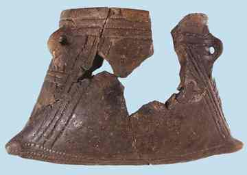 A ceramic vessel. Like the bones, the ceramic was broken up into little pieces and scattered into the pits. 