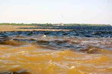 The 'Meeting of Waters' is where two great rivers collide, mixing their different colored waters to form the behemoth Amazon river.