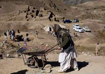 Men work on the excavation of a sprawling 2,600-year-old Buddhist monastery in Mes Aynak, south of Kabul, Afghanistan. The archaeological dig is located at the world's second-biggest unexploited copper mine. The Chinese government-backed mining company, China Metallurgical Group Corp., which won the contract to exploit the site, has given archaeologists three years to finish the excavations. Photo: Dusan Vranic / AP 