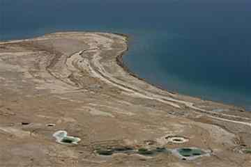 n this June 20, 2006 file photo, pools of water are seen where the Dead Sea once reached. Scientists in Israel are drilling into the murky depths of the Dead Sea in hopes of unearthing scientific treasures found in 500,000 years worth of mud and sediment. The unique setting of the Dead Sea, the lowest place on earth at 422 meters (1,385 feet) below sea level, should present researchers with distinctly stratified sedimentation that may answer scientific questions ranging from geology to archaeology and could lead to new insight into climate change.