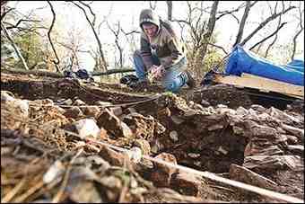 Stephan Woehlke, an archeologist with the Colchester Archeological Research Team carefully removes dirt from an 18th century feature of the port town of Colchester. 