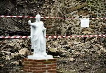 Tuesday, a stretch of garden wall ringing the ancient House of the Moralist gave way, intensifying calls for action at the archeological site. Officials played down yesterday’s damage. (Roberto Salomone/ AFP/ Getty Images) 