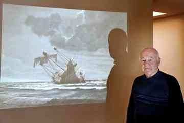 Sheldon Breiner of Portola Valley is searching for the sunken galleon he believes is the San Felipe. A slide image of a painting of the San Felipe is projected on a wall at his home. Photo by Michelle Le/The Almanac.