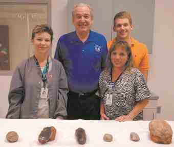 Standing with a variety of dinosaur eggs are, from left, Rebecca Petty, Dr. Neal Naranjo, J. Neal Naranjo and April Smith.