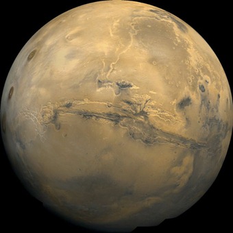 At the center of this Martian orbital image is Valles Marineris, over 3000 km long and up to 8 km deep. [Image credits: NASA / GSFC]
