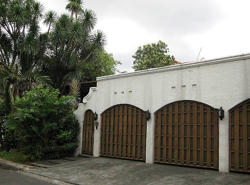 house with white walls and wooden gates