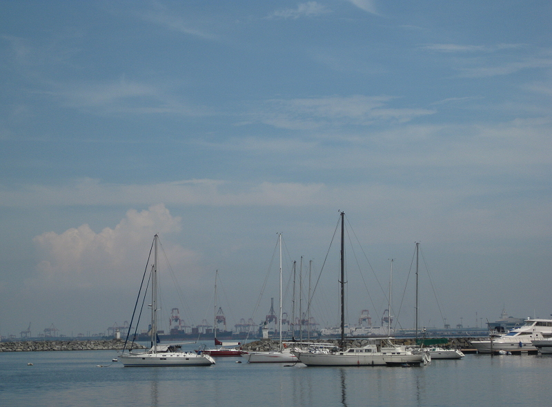 sailboats and gantry cranes in Manila Bay