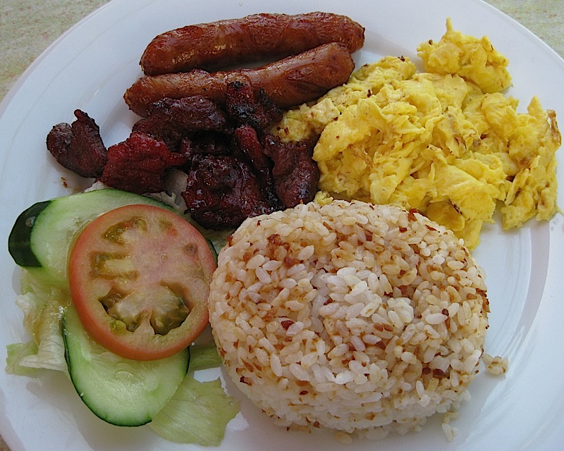 Filipino breakfast consisting of fried garlic rice, eggs, tapa, tocino and longganisa
