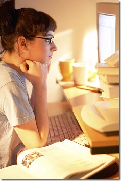 girl_at_computer_with_open_book