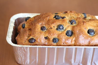 close-up photo of a loaf of Blueberry banana bread in a loaf pan