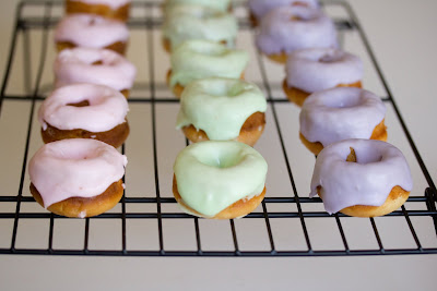 photo of Frosted mini sugar donuts on a baking rack