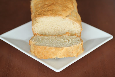 photo of loaf of honey beer bread with a slice cut off