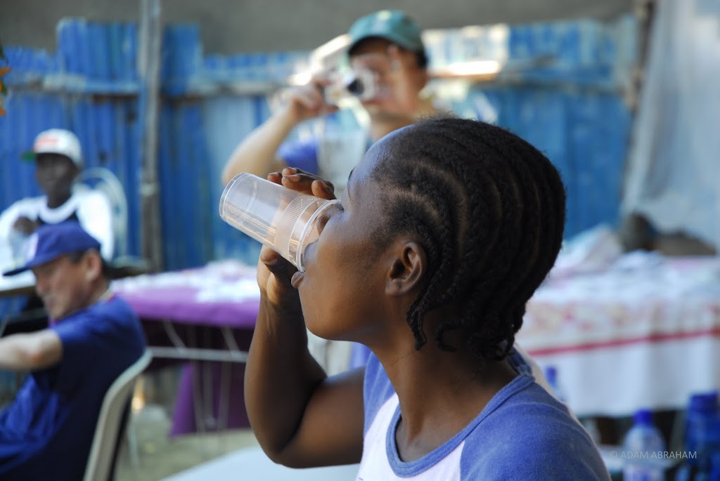 A Haitian woman drinks MMS in Port-au-Prince medical mission.