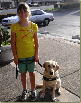 My little future guide dog puppy raiser with Reyna.  Sara has a big smile on her face.