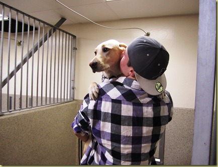 Reyna is in Tyler's arms and he his kissing her cheek as they say good bye in the kennel.