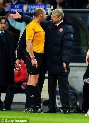 Arsenal physical education instructor Arsene Wenger argues with arbitrate Martin Hansson