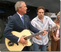 George Bush playing guitar while...