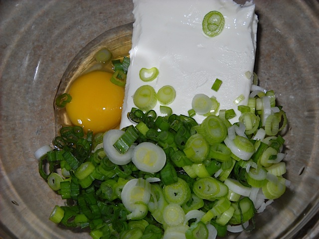 cream cheese, green onions, egg and Sriracha in a bowl