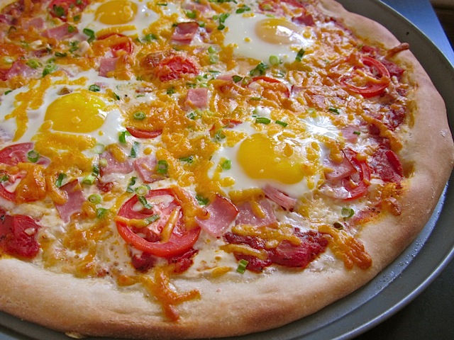 Close up of breakfast pizza on pan 