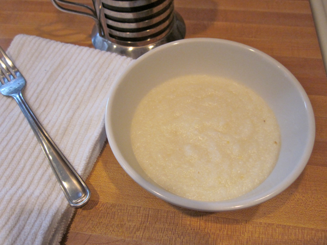 grits in white bowl with fork on side 