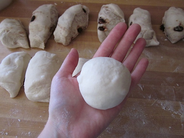 dough formed into small ball with rest of dough on counter 