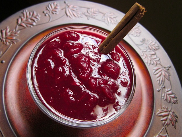 Red Wine Cranberry Sauce in bowl with cinnamon stick 