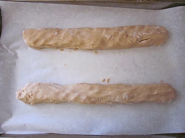 biscotti dough formed into two logs and placed on baking sheet lined with parchment paper