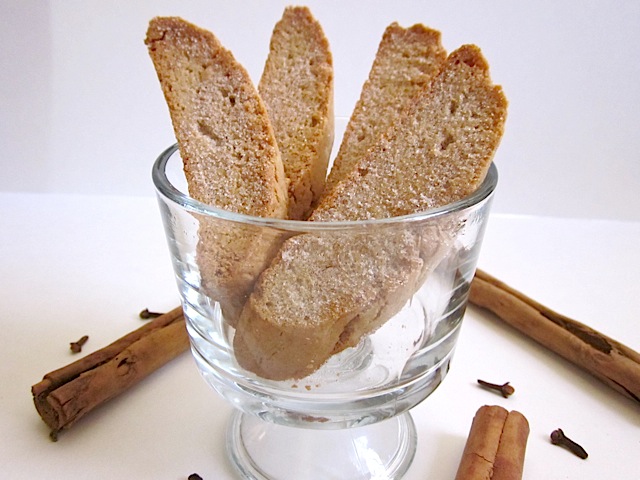 Cinnamon Spice Biscotti staged in clear mug with cinnamon sticks on the side 