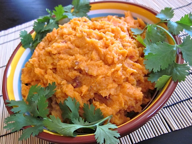 Bowl of chipotle mashed sweet potatoes garnished with parsley 