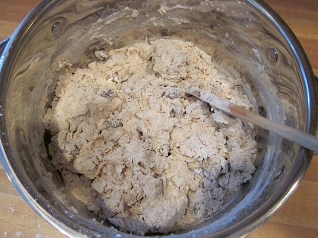 water added to dry ingredients in mixing bowl 
