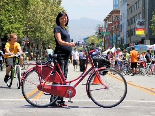 Pregnant woman with red Dutch bike in California
