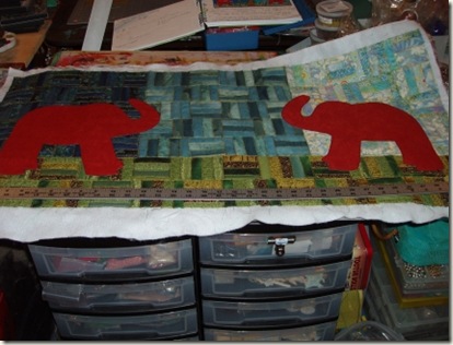 11 elephants pinned to quilt background
